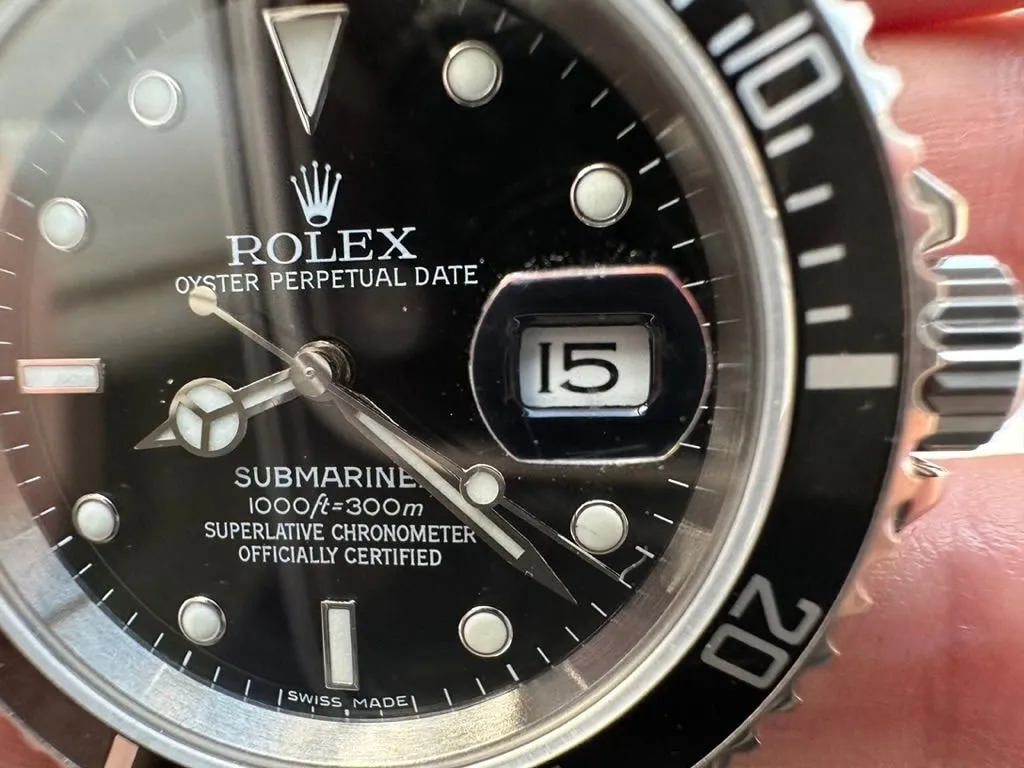 Black dial and aluminium bezel of a Submariner 16610 style franken build